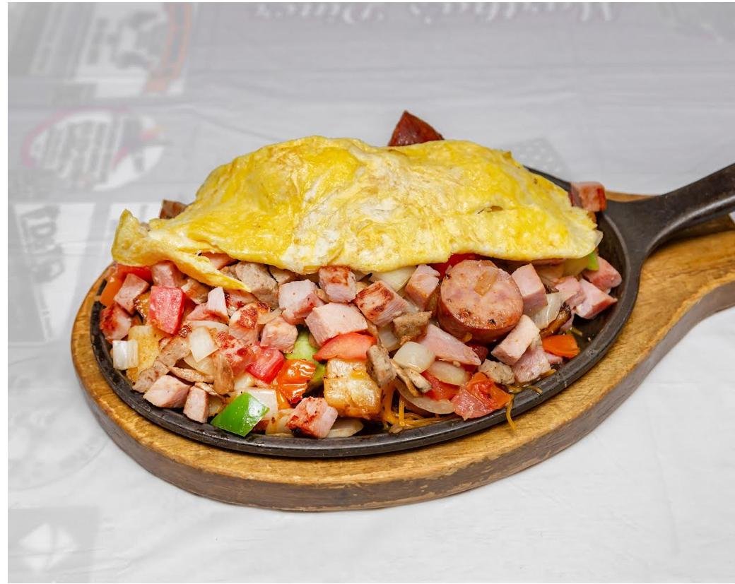 Loaded breakfast skillet topped with an omelet